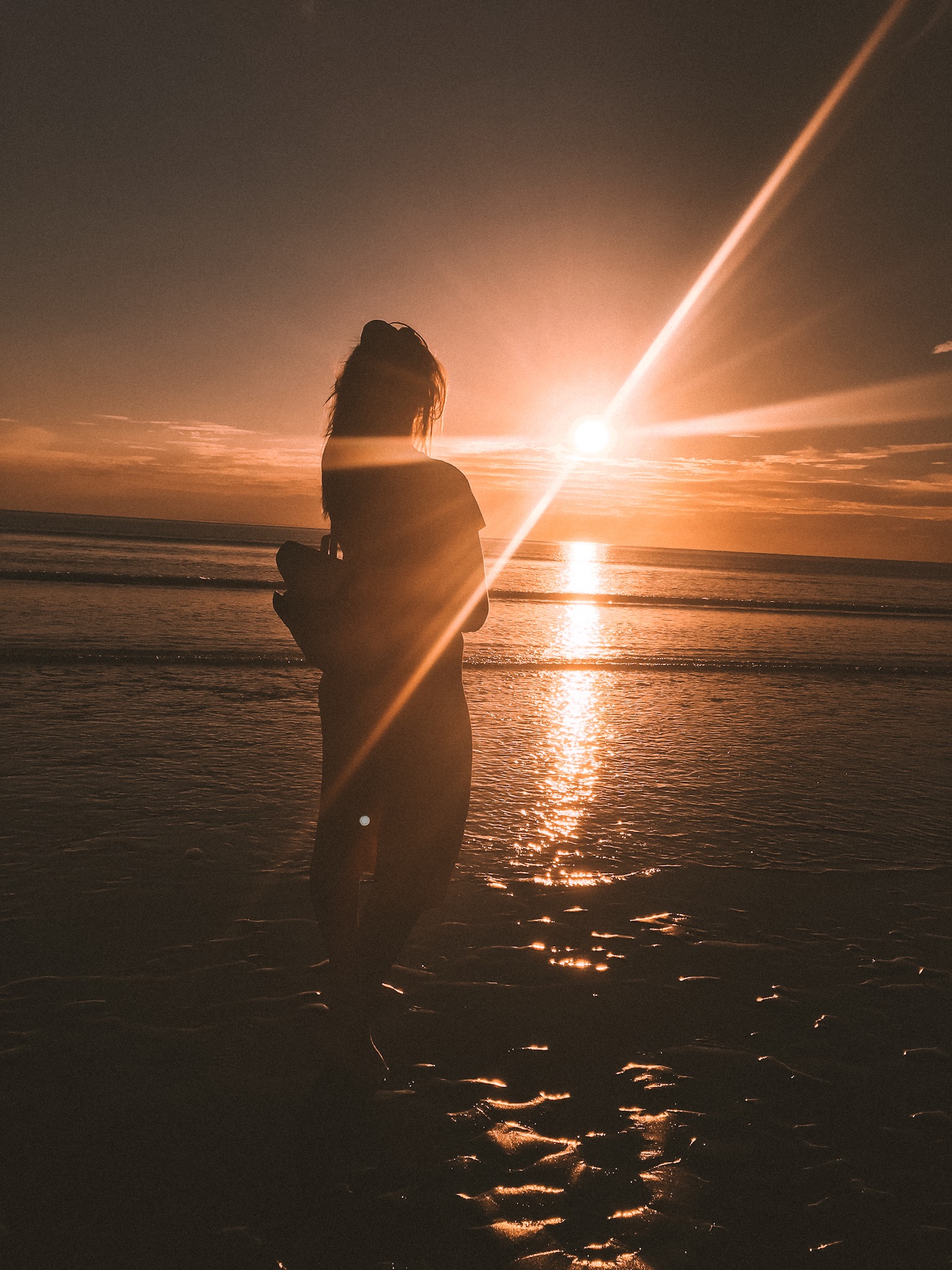 Girl on beach at sunset