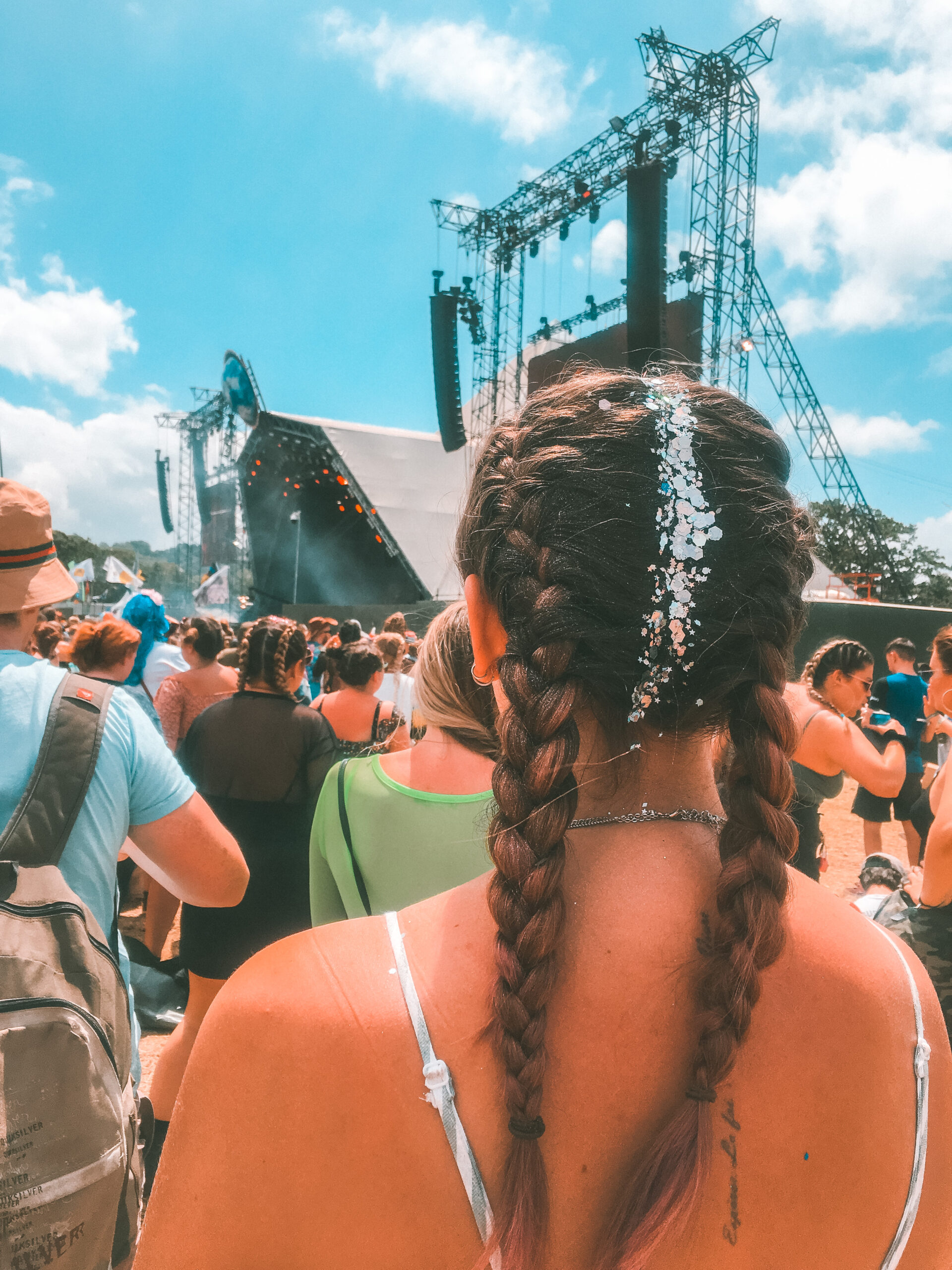 girl with plaits and glitter in hair at a UK day dance festival