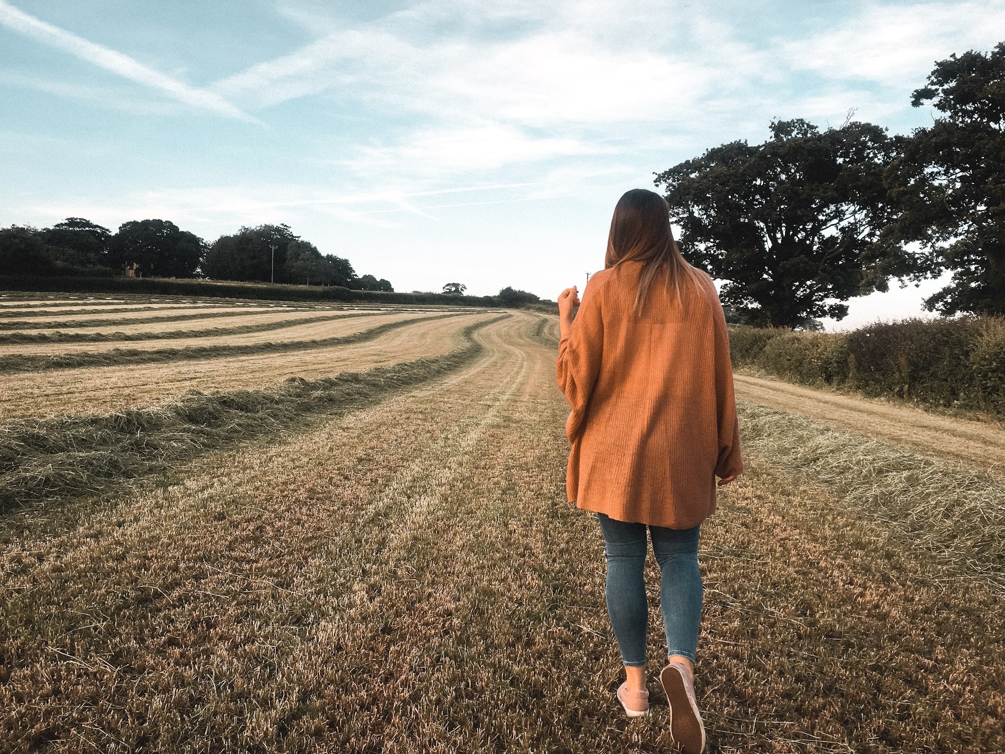 Girl walking in field during summer
